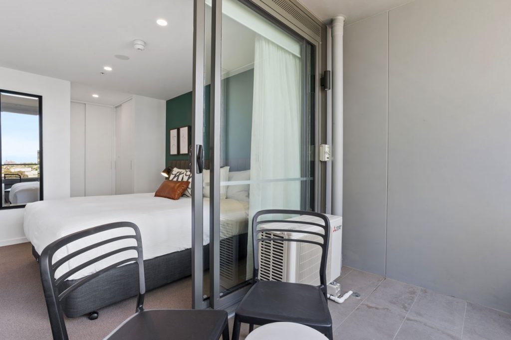 King bed and balcony at The Sebel Moonee Ponds