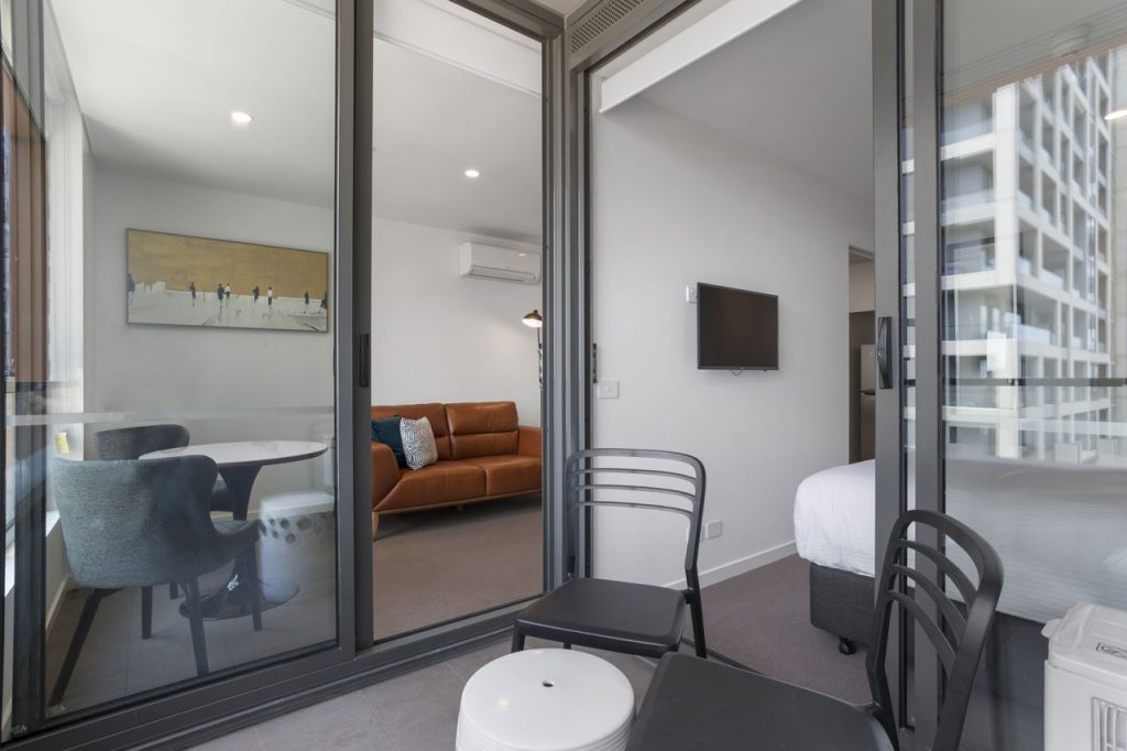 Lounge room and balcony at The Sebel Moonee Ponds