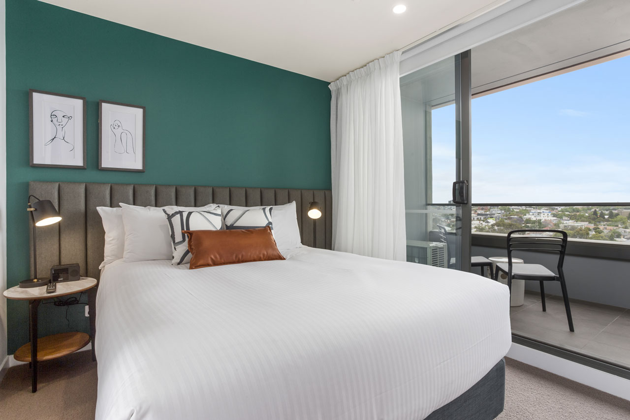 queen bed and balcony at The Sebel Moonee Ponds