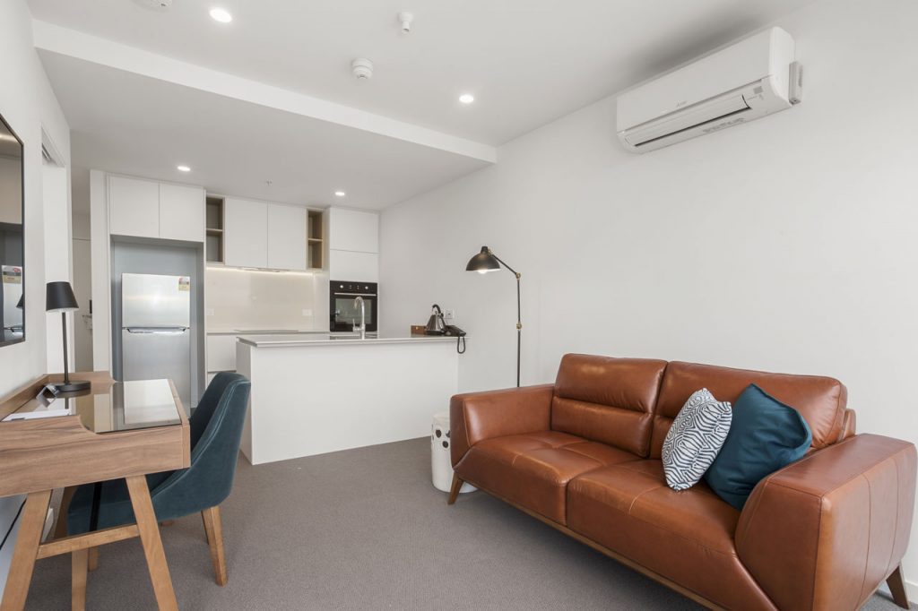 Lounge and kitchen in 1 bedroom with king apartment at The Sebel Moonee Ponds