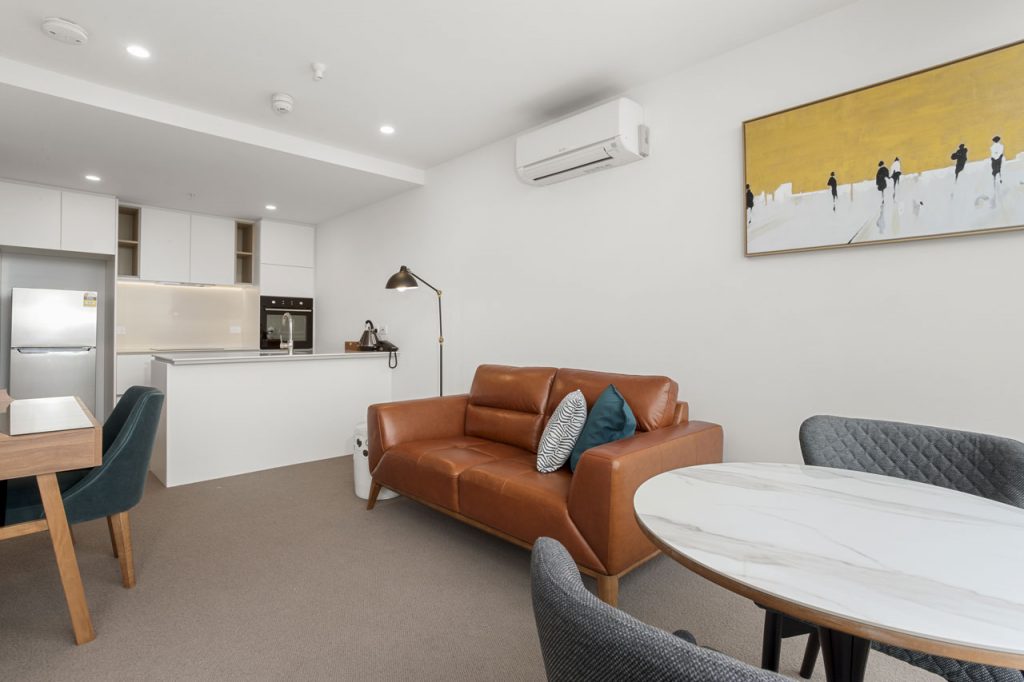 Lounge and kitchen in 1 bedroom apartment king at The Sebel Moonee Ponds